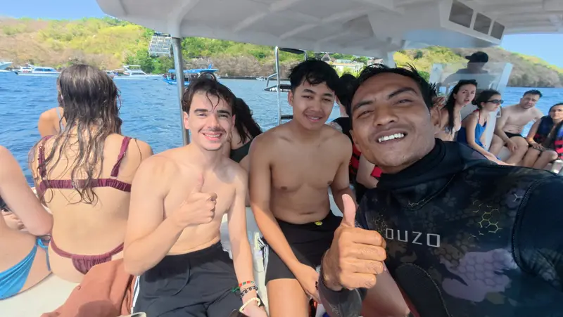 Happy guests with their snorkeling guide on the boat