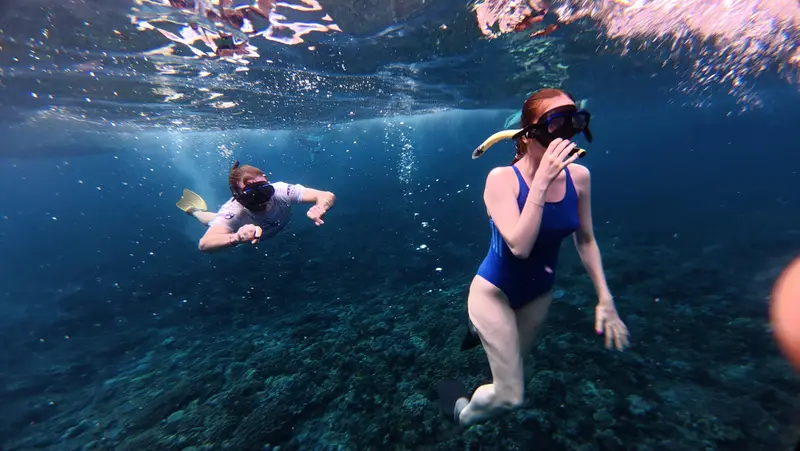 Snorkeler waving underwater